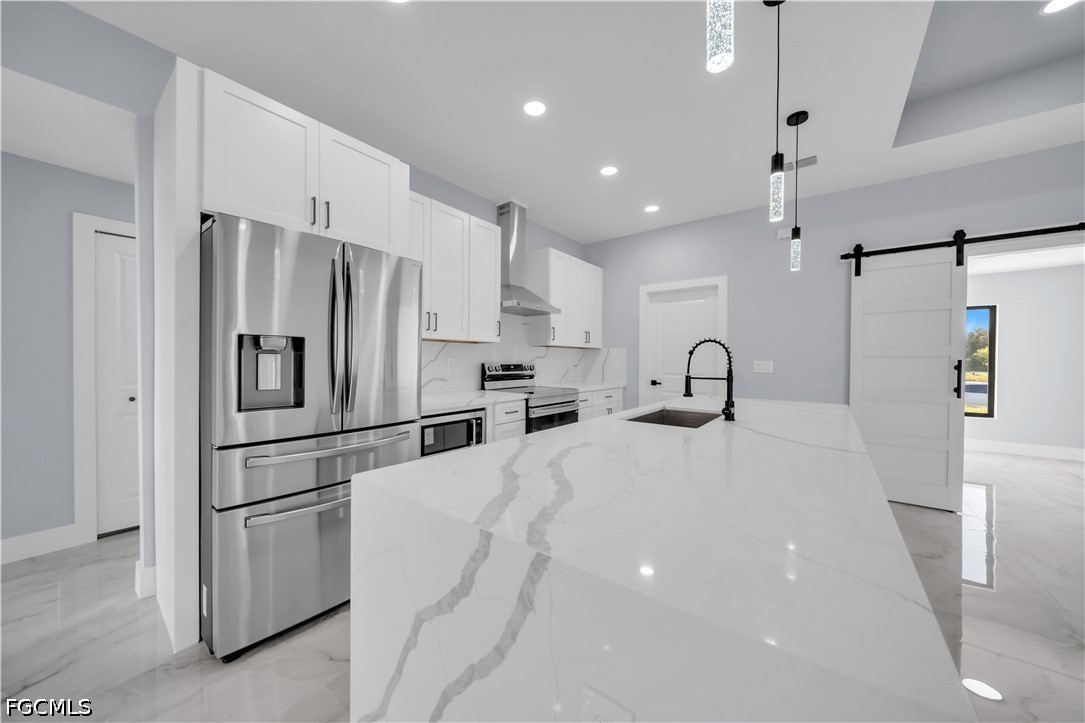 4028 26th Street Southwest Lehigh Acres, FL 33976 - Photo 14 of 38 a kitchen with granite countertop a refrigerator and a sink