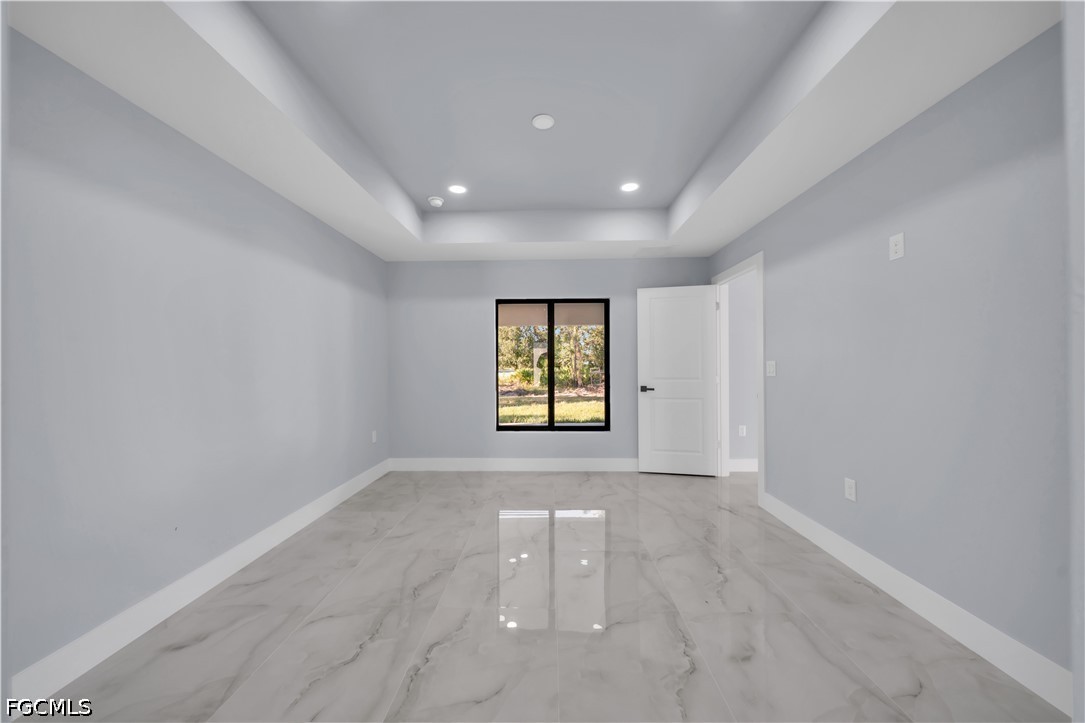 4028 26th Street Southwest Lehigh Acres, FL 33976 - Photo 20 of 38 wooden floor in an empty room with a window