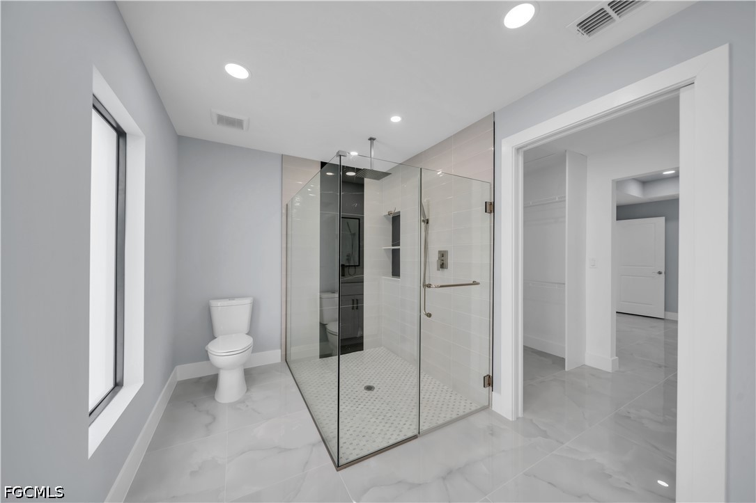 4028 26th Street Southwest Lehigh Acres, FL 33976 - Photo 27 of 38 a bathroom with a shower and a toilet