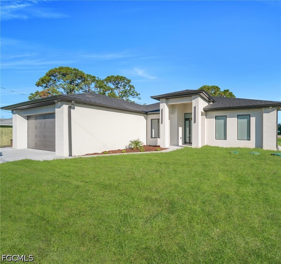 4028 26th Street Southwest Lehigh Acres, FL 33976 - Photo 3 of 38 a view of a house with a yard
