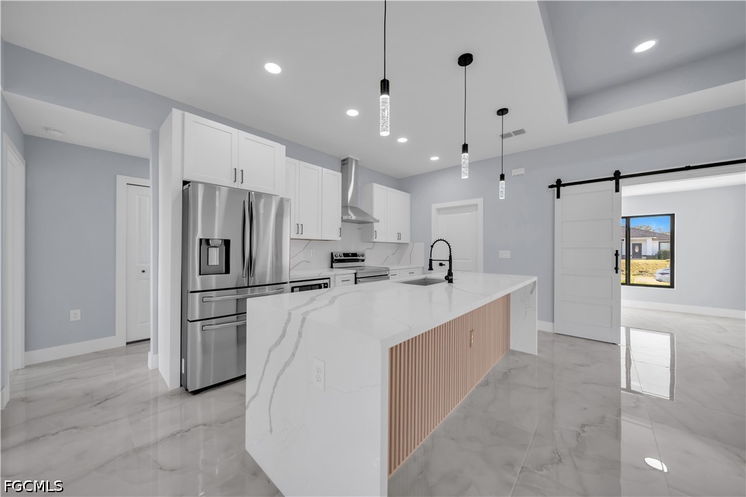 4028 26th Street Southwest Lehigh Acres, FL 33976 - Photo 7 of 38 a large kitchen with stainless steel appliances a refrigerator and a refrigerator