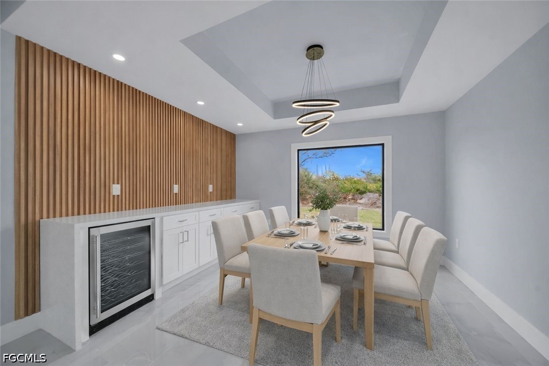 4028 26th Street Southwest Lehigh Acres, FL 33976 - Photo 8 of 38 a view of a dining room with furniture wooden floor chandelier and a rug