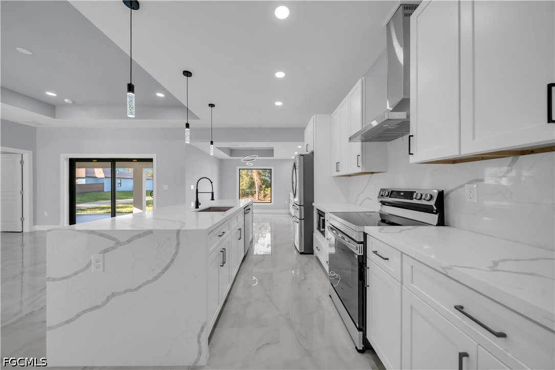 4028 26th Street Southwest Lehigh Acres, FL 33976 - Photo 10 of 38 a kitchen with white cabinets appliances and a window