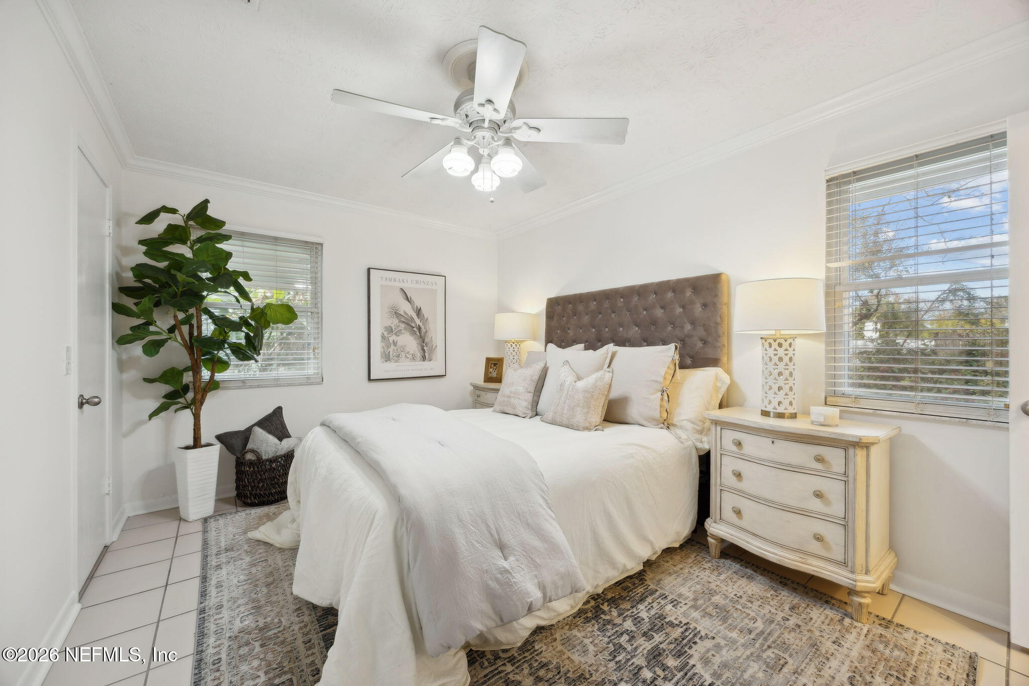 600 Davis Street Neptune Beach, FL 32266 - Photo 14 of 33 a bedroom with a large bed and a chandelier