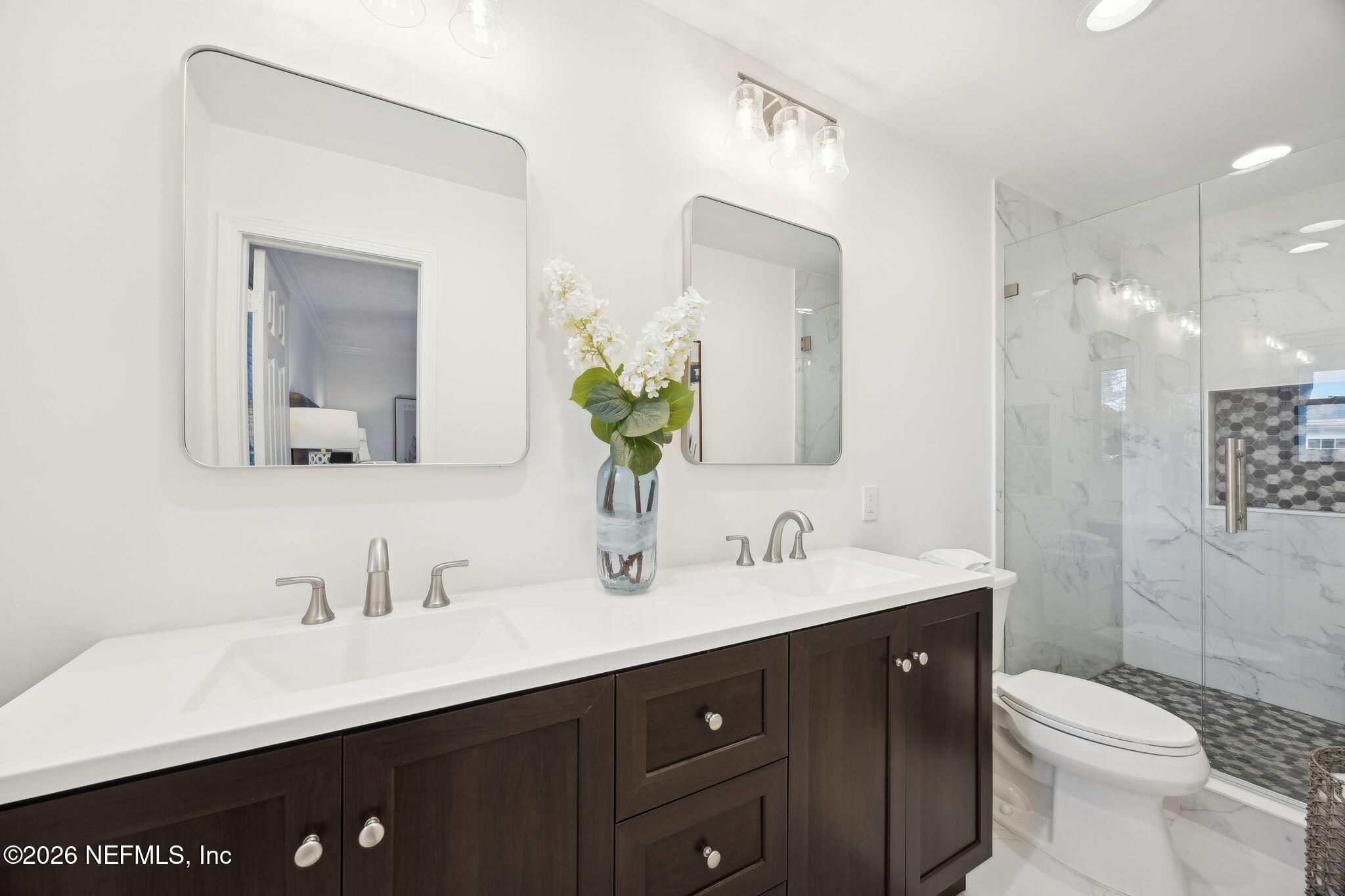 600 Davis Street Neptune Beach, FL 32266 - Photo 15 of 33 a bathroom with a double vanity sink toilet and a mirror