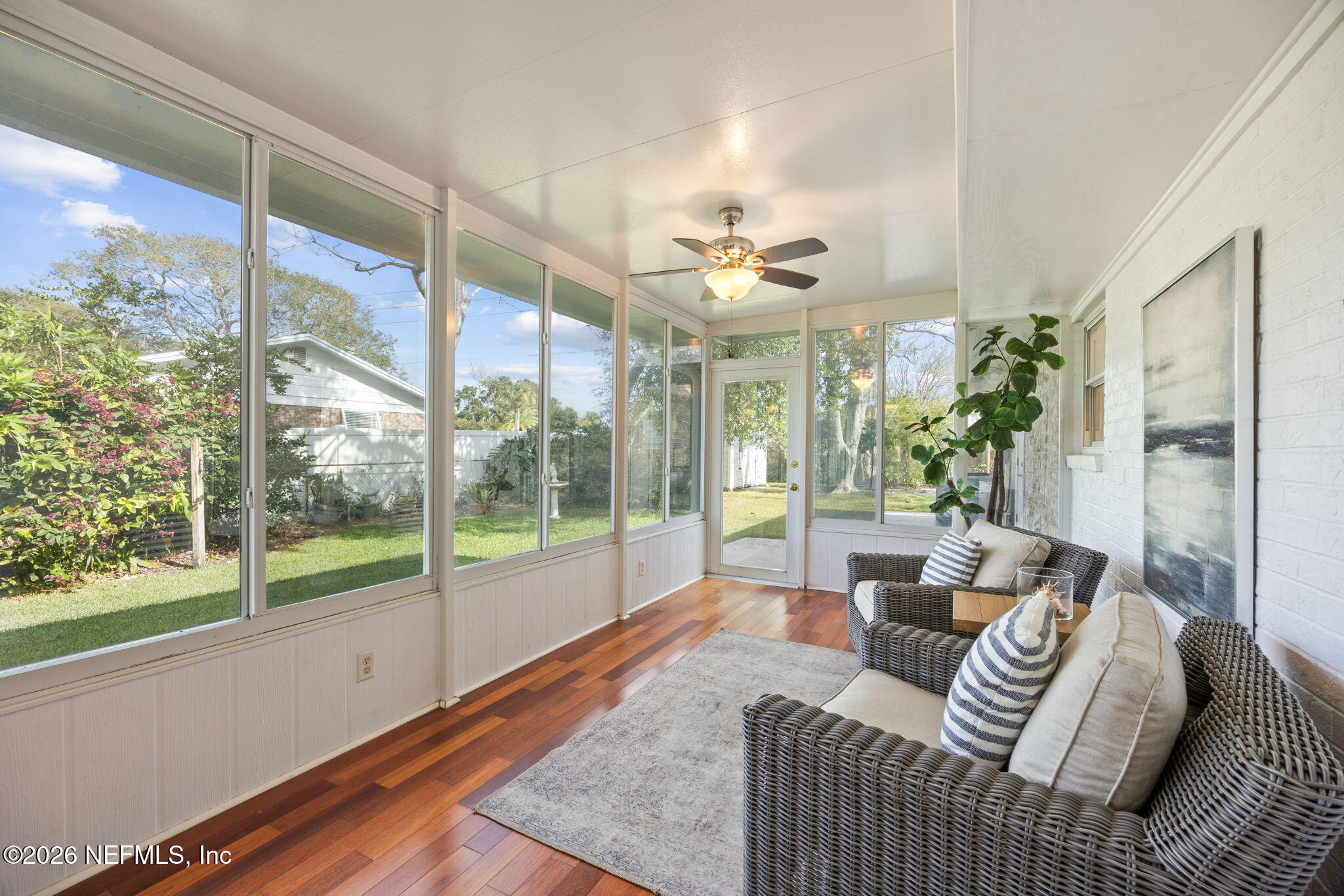 600 Davis Street Neptune Beach, FL 32266 - Photo 22 of 33 a living room with furniture and a floor to ceiling window