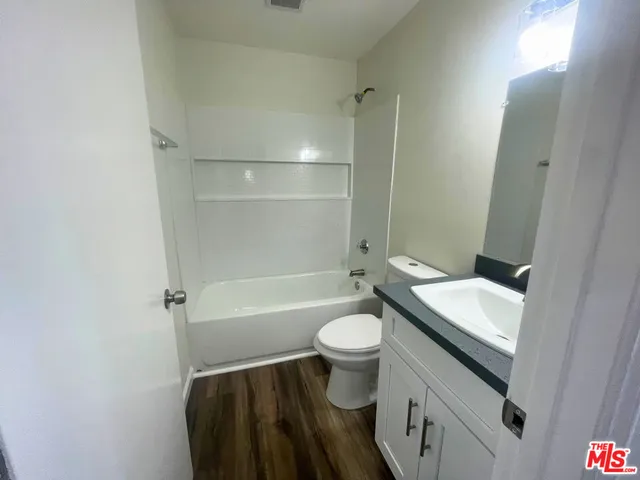 a bathroom with a sink toilet a mirror and shower