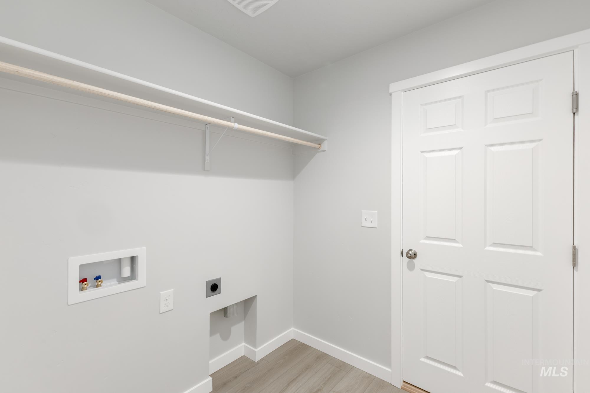 16264 Fill Avenue Caldwell, ID 83607 - Photo 13 of 18 Laundry area featuring washer hookup, light wood-style floors, and electric dryer hookup