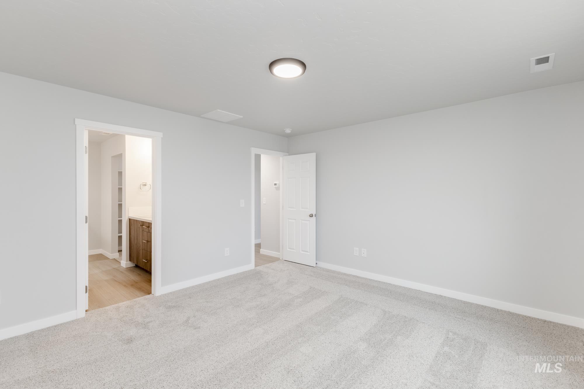 16264 Fill Avenue Caldwell, ID 83607 - Photo 15 of 18 Unfurnished bedroom featuring light carpet and ensuite bathroom