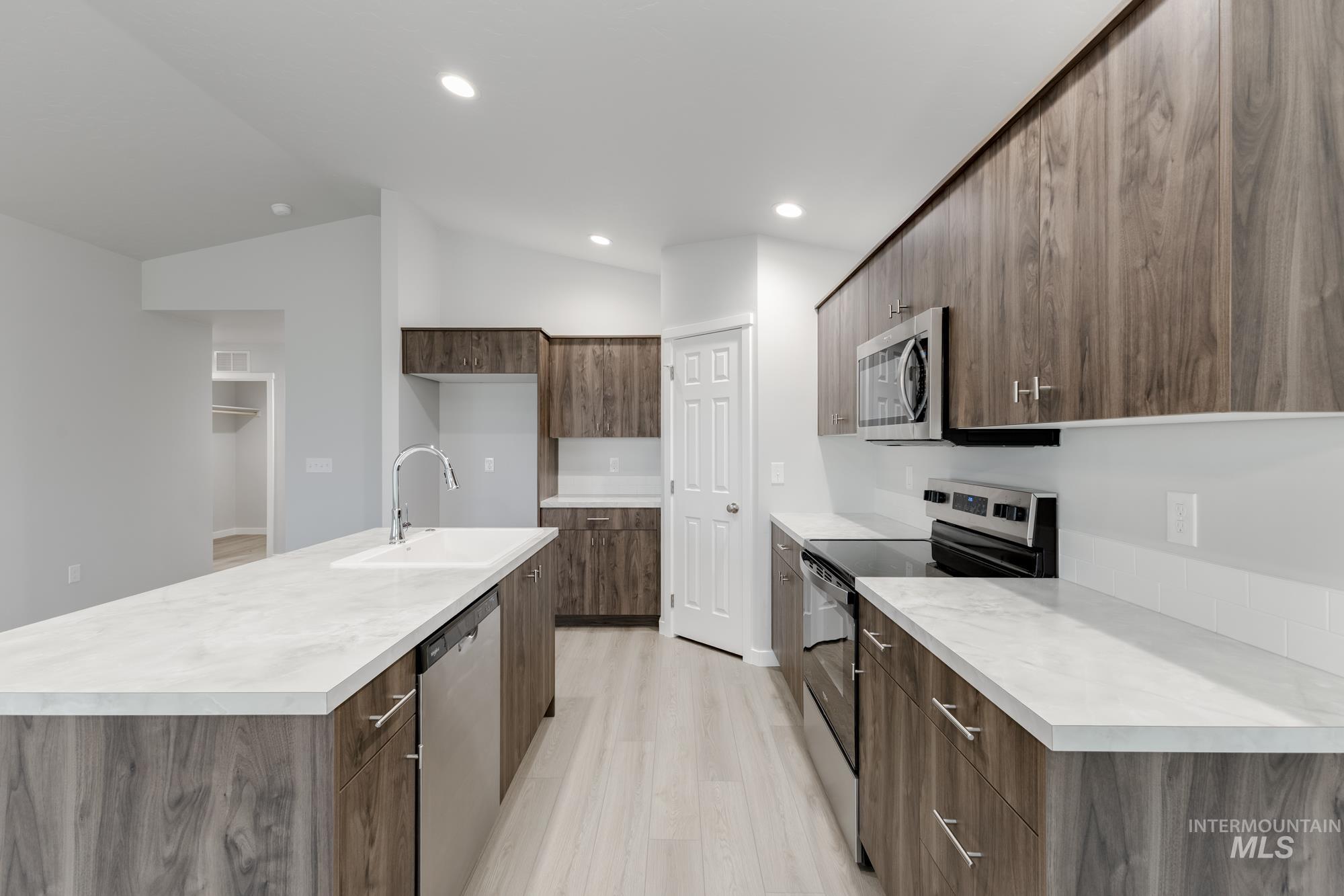 16264 Fill Avenue Caldwell, ID 83607 - Photo 5 of 18 Kitchen with appliances with stainless steel finishes, light countertops, modern cabinets, an island with sink, and recessed lighting