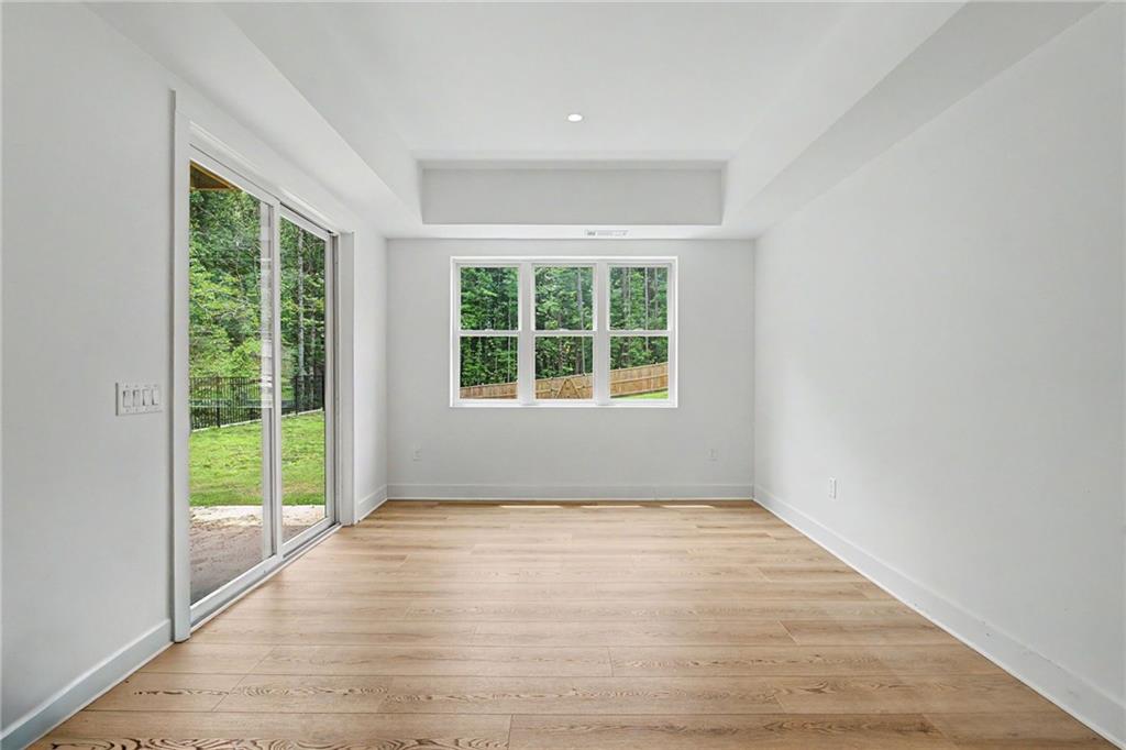 376 Hunnicut Road Southeast Mableton, GA 30126 - Photo 57 of 73 an empty room with wooden floor and windows