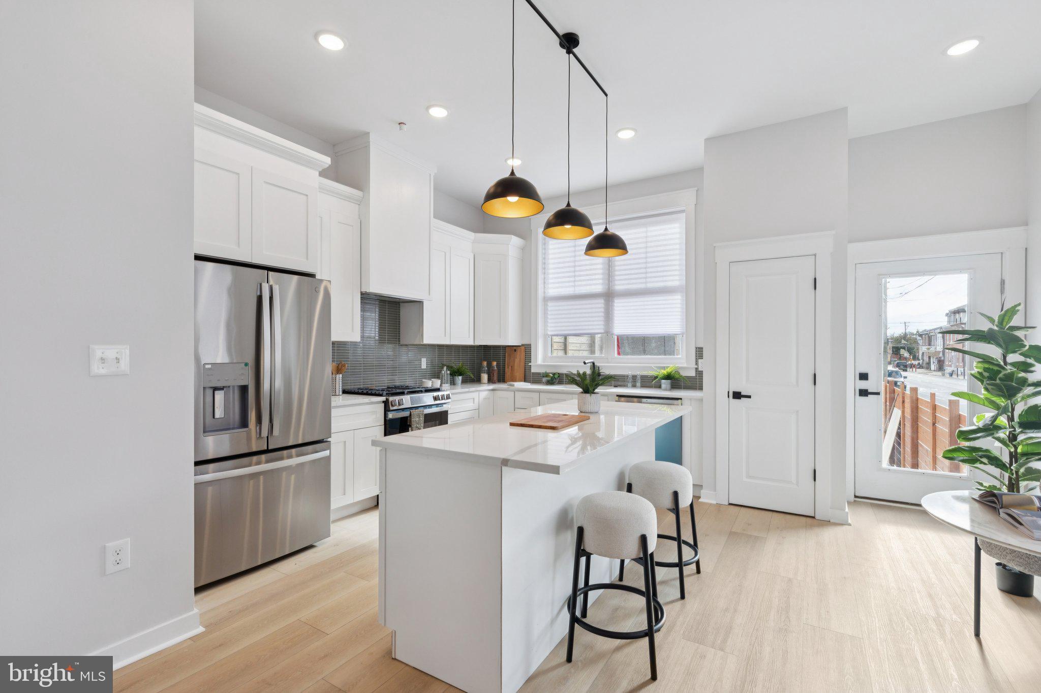 2800 Bridge Street Philadelphia, PA 19137 - Photo 15 of 51 a kitchen with kitchen island a counter top space a sink stainless steel appliances and cabinets