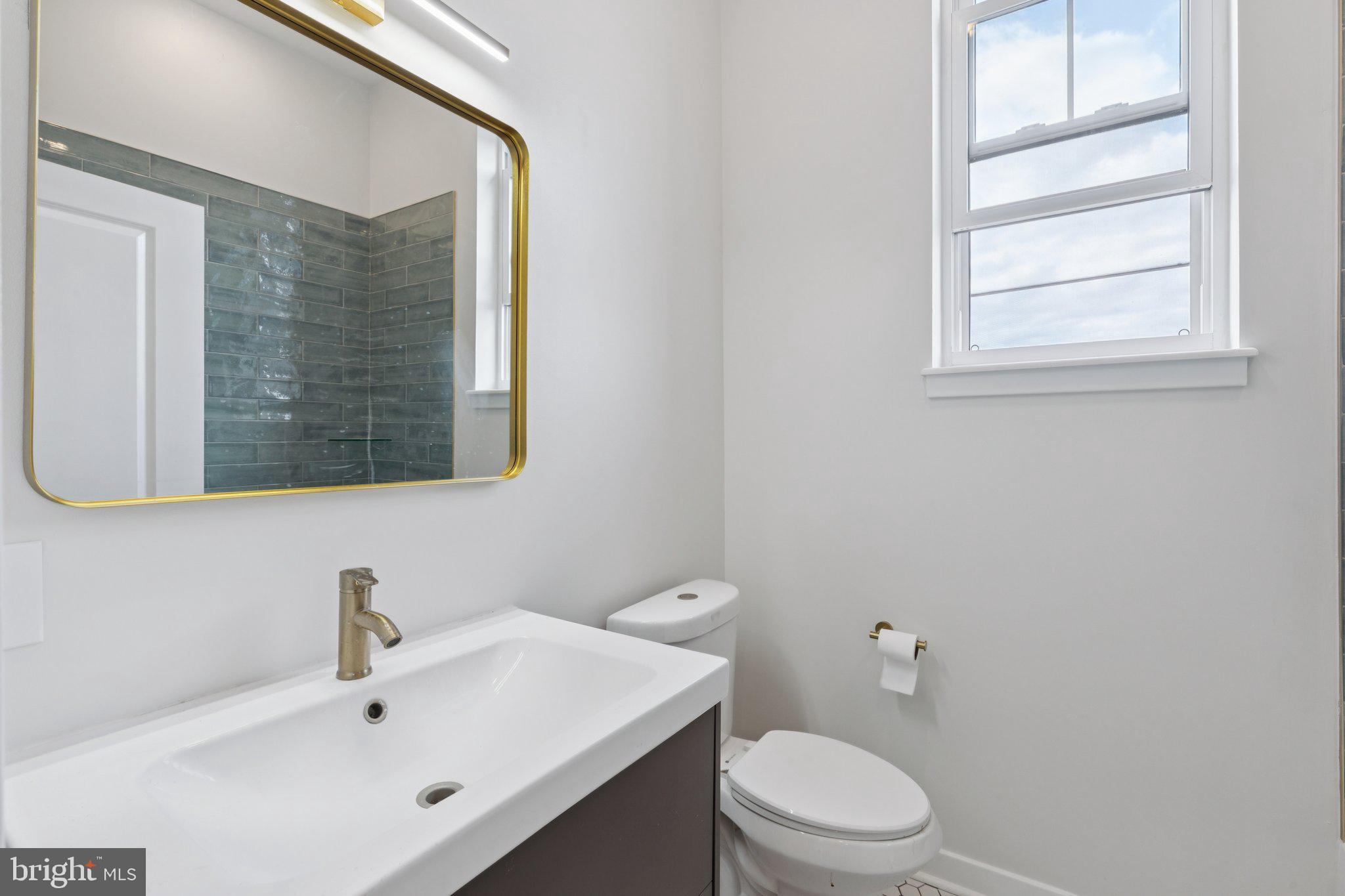2800 Bridge Street Philadelphia, PA 19137 - Photo 32 of 51 a bathroom with a toilet a sink and mirror