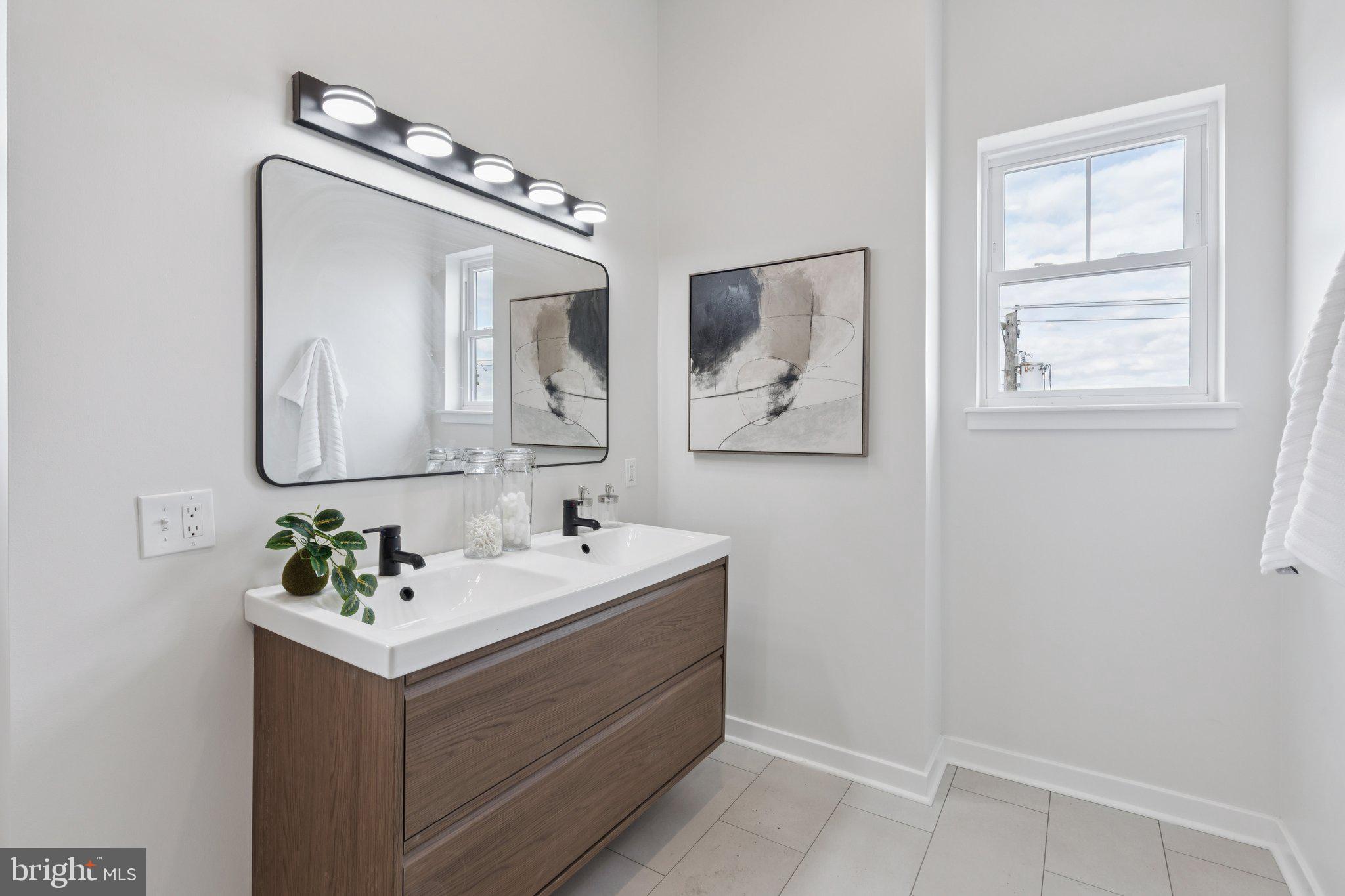 2800 Bridge Street Philadelphia, PA 19137 - Photo 42 of 51 a bathroom with a double vanity sink and mirror