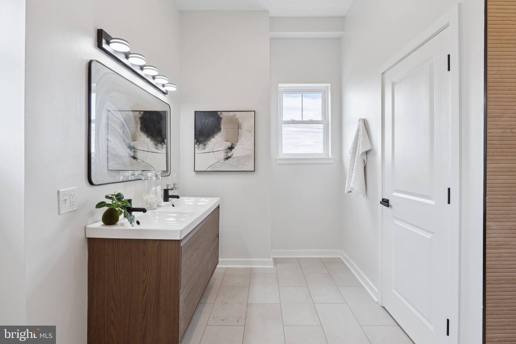 2800 Bridge Street Philadelphia, PA 19137 - Photo 43 of 51 a bathroom with a sink a mirror and a window