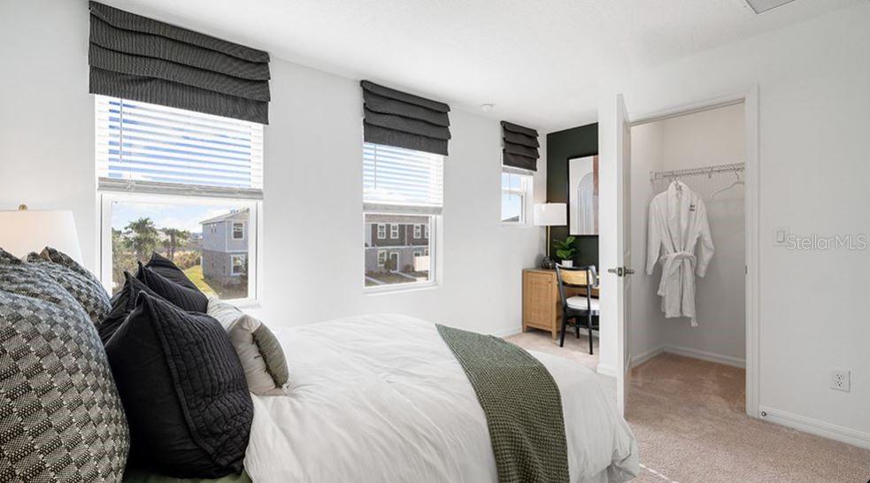 14064 Textile Run Parrish, FL 34219 - Photo 11 of 22 a bedroom with a bed and a dresser next to a window