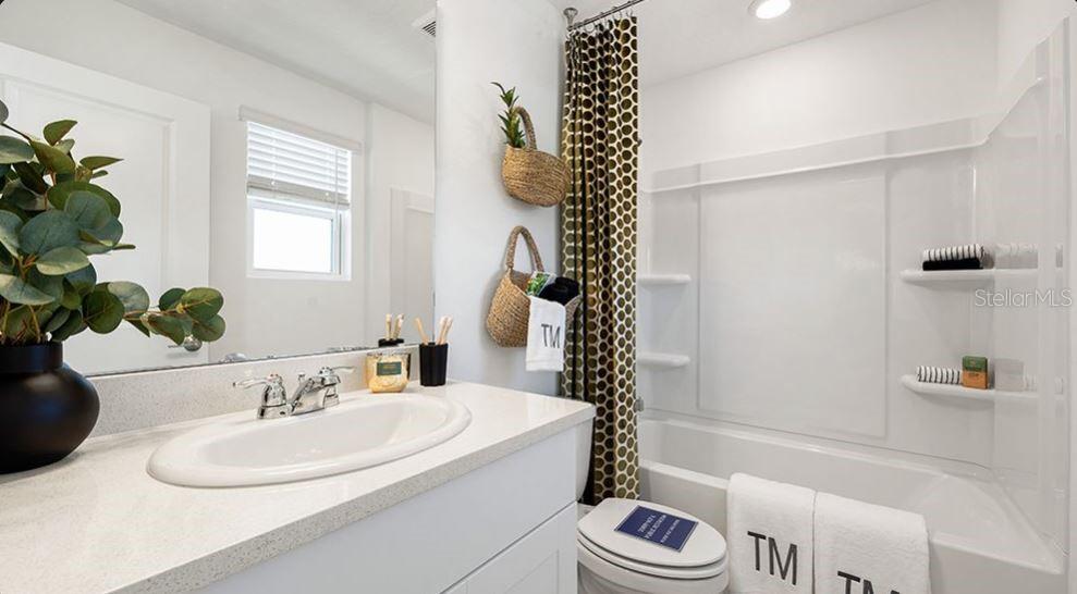 14064 Textile Run Parrish, FL 34219 - Photo 12 of 22 a bathroom with a sink a toilet and a bathtub