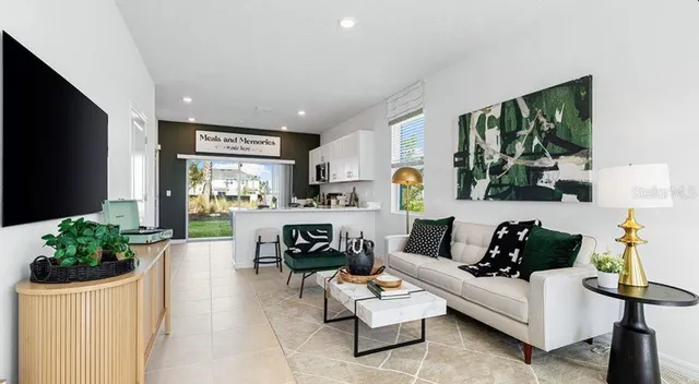 a dining room with furniture a window and wooden floor