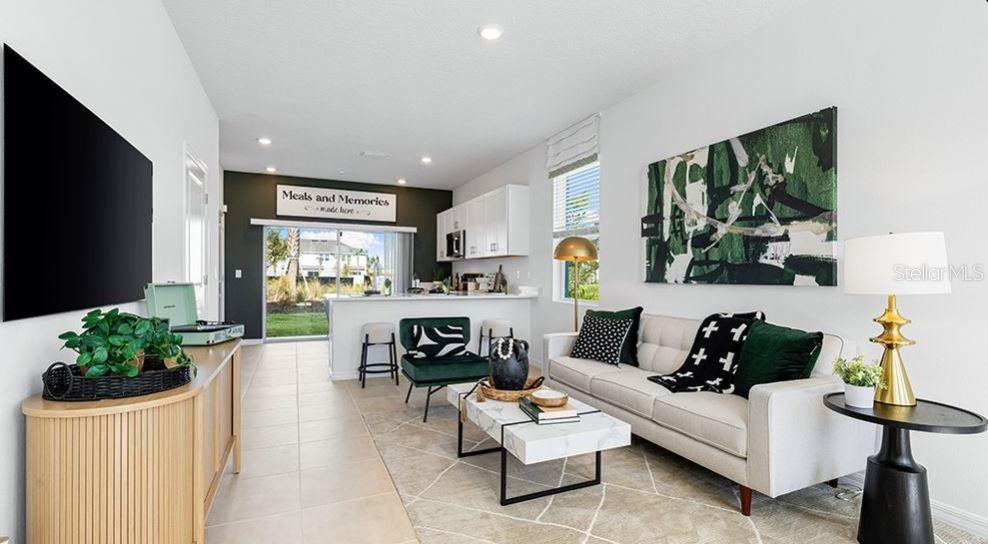 14064 Textile Run Parrish, FL 34219 - Photo 5 of 22 a living room with furniture potted plant and a flat screen tv
