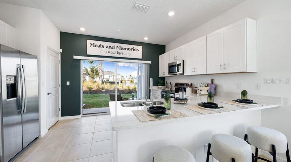 14064 Textile Run Parrish, FL 34219 - Photo 6 of 22 a kitchen with stainless steel appliances granite countertop a sink and cabinets
