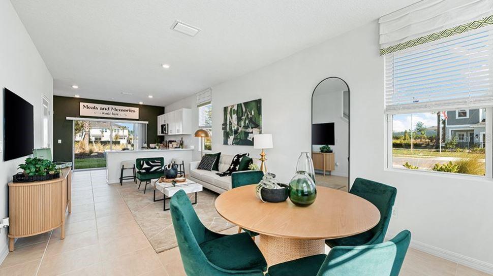 14064 Textile Run Parrish, FL 34219 - Photo 7 of 22 a dining room with furniture a window and wooden floor