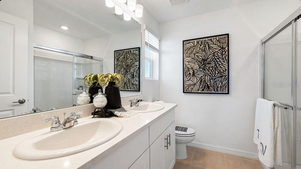 14064 Textile Run Parrish, FL 34219 - Photo 9 of 22 a bathroom with a toilet sink and mirror