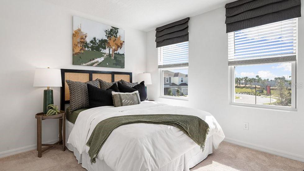 14064 Textile Run Parrish, FL 34219 - Photo 10 of 22 a bed sitting in a bedroom next to a window