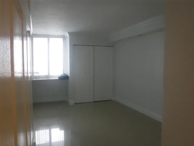 an empty room with a empty space and windows