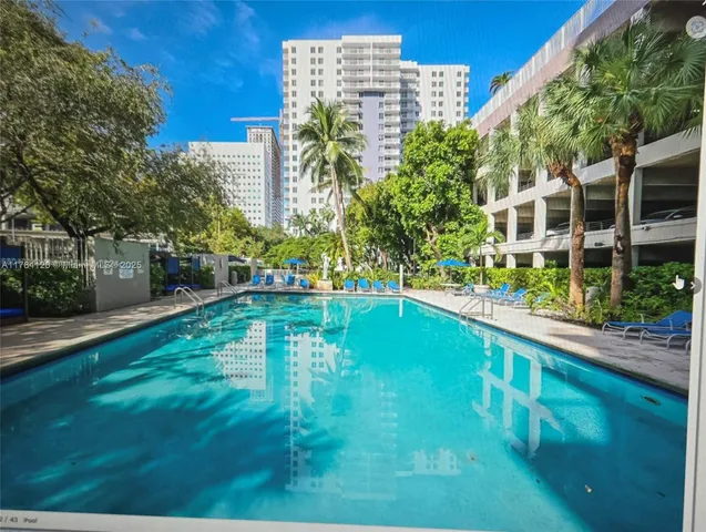 a view of a park with plants and large trees