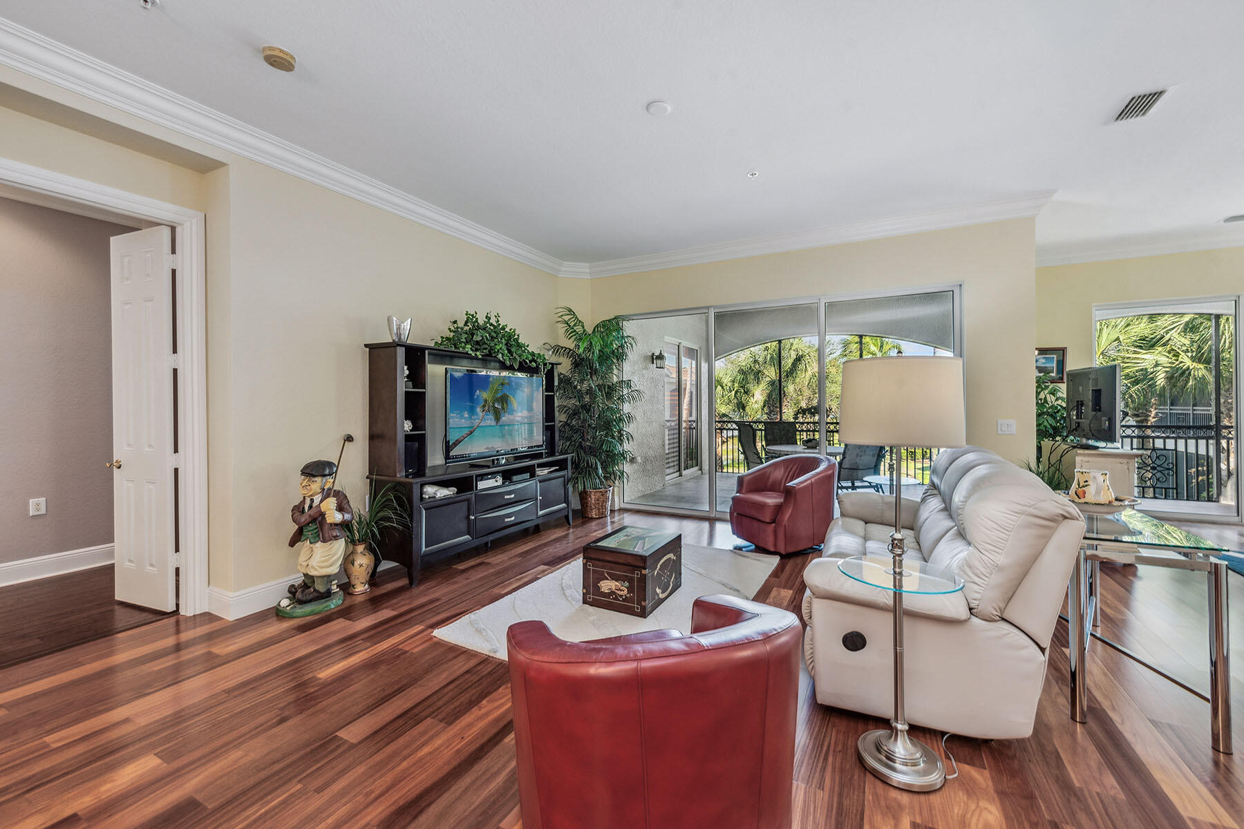 3189 Aviamar Circle, Unit 202 Naples, FL 34114 - Photo 2 of 50 a living room with furniture and a flat screen tv