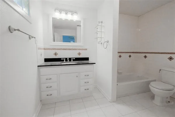 a bathroom with a toilet sink and shower