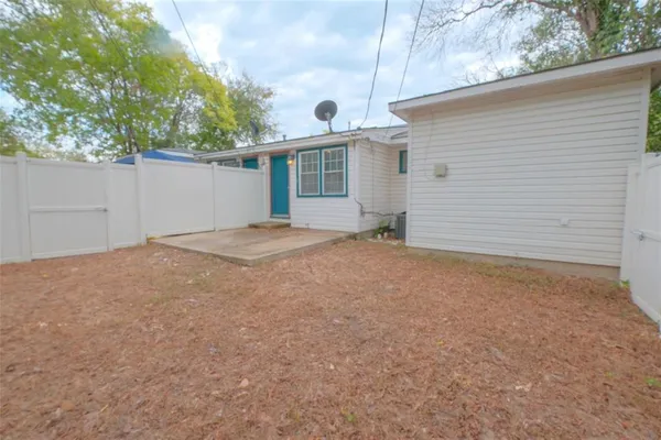 a view of a house with a yard and potted plants