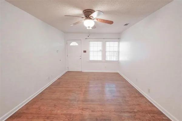 wooden floor in an empty room with a window