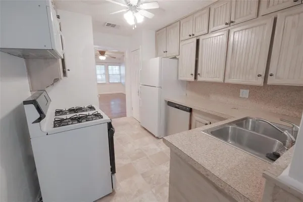 a kitchen that has a sink and a stove