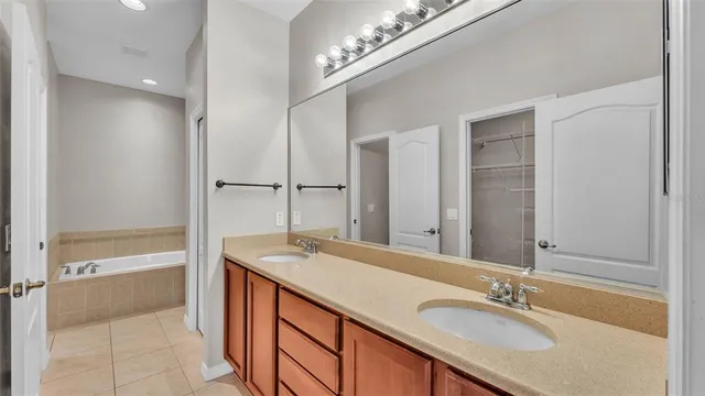 a bathroom with a granite countertop sink a mirror and a shower