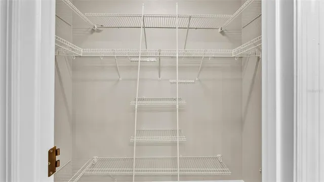 an empty room with a ceiling fan and a window