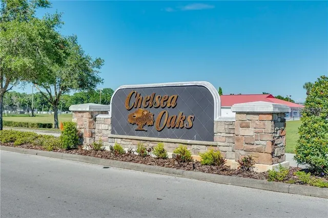a view of a water pond with green yard