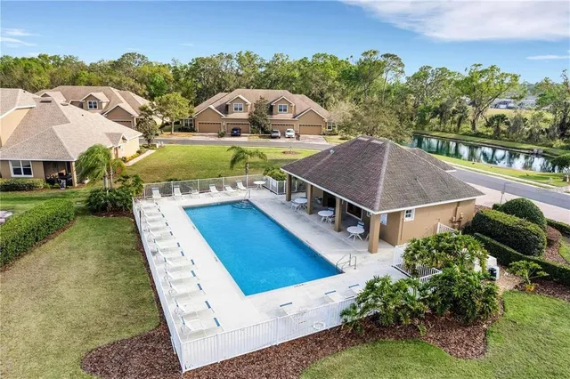 a view of a house with swimming pool and a yard