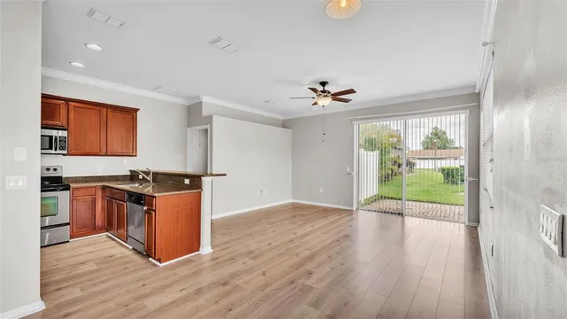 a view of a kitchen with a sink wooden floor and a kitchen
