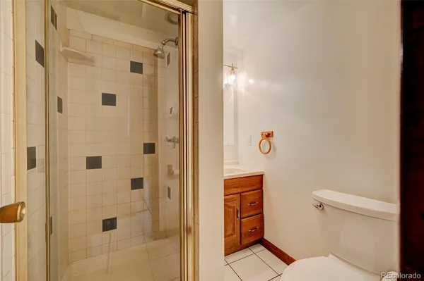 a bathroom with a toilet and a shower