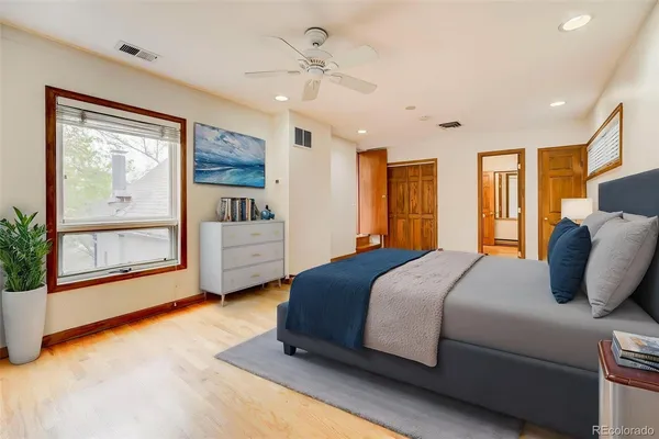 a bedroom with a large bed and a chandelier