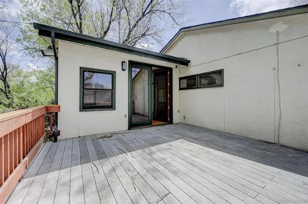 a view of backyard with a deck and wooden floor