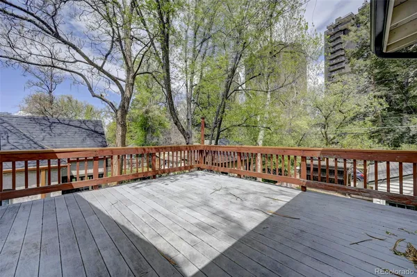 a view of balcony with wooden floor and fence