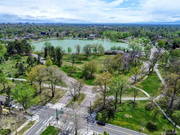 an aerial view of green landscape with trees houses and mountain view