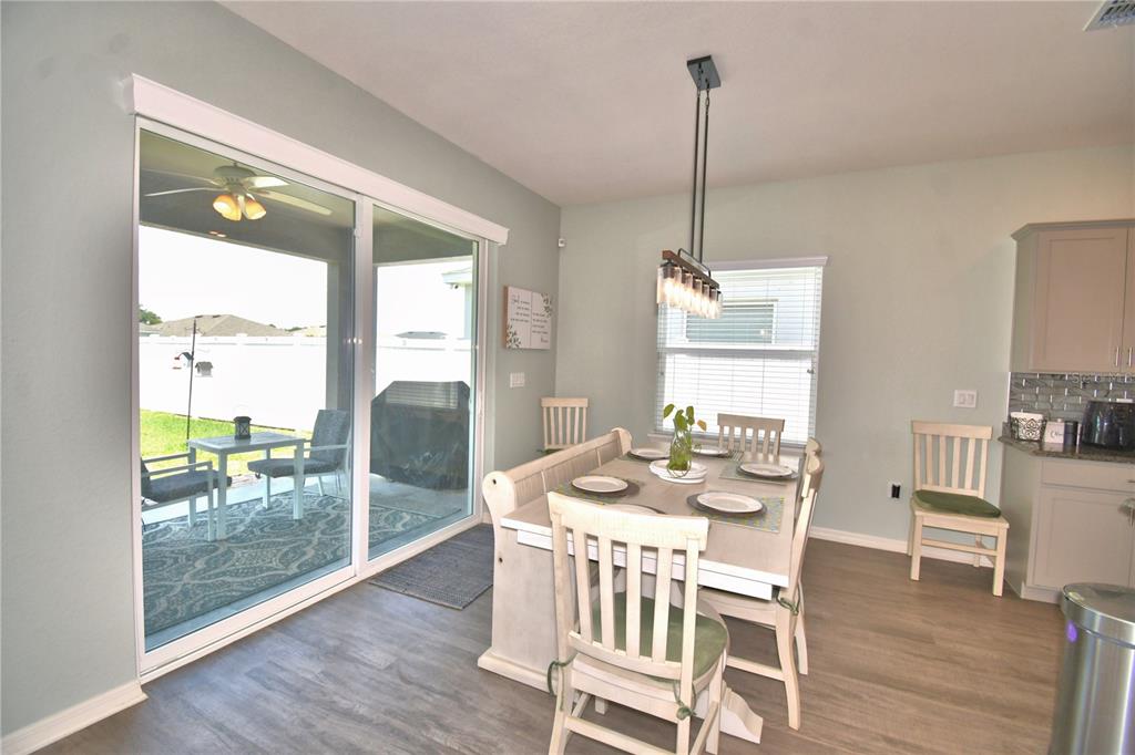 4340 Reding Way Lakeland, FL 33813 - Photo 51 of 63 a dining room with furniture large windows and wooden floor