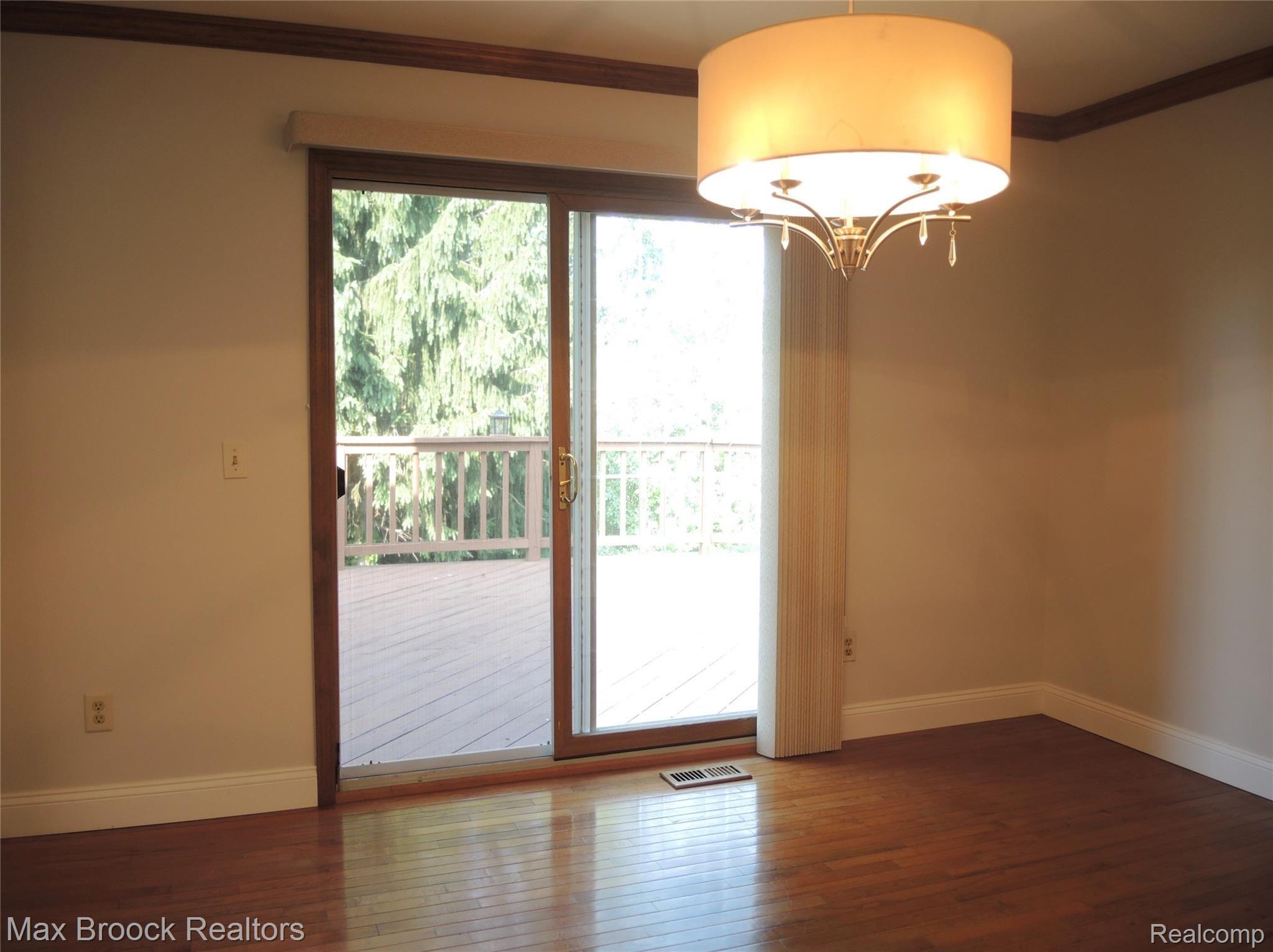 1240 Bembridge Drive Rochester, MI 48307 - Photo 14 of 48 FORMAL DINING ROOM WITH VIEW OF DECK & YARD