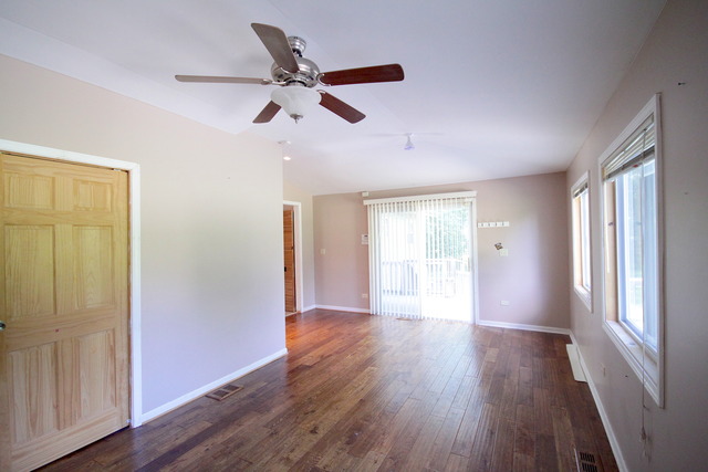 4N041 Edwards Drive Addison, IL 60101 - Photo 8 of 21 a view of an empty room with wooden floor and a window