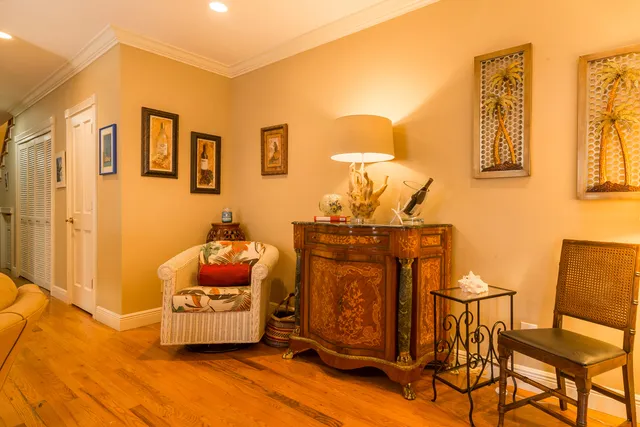 a living room with furniture wooden floor and a large window