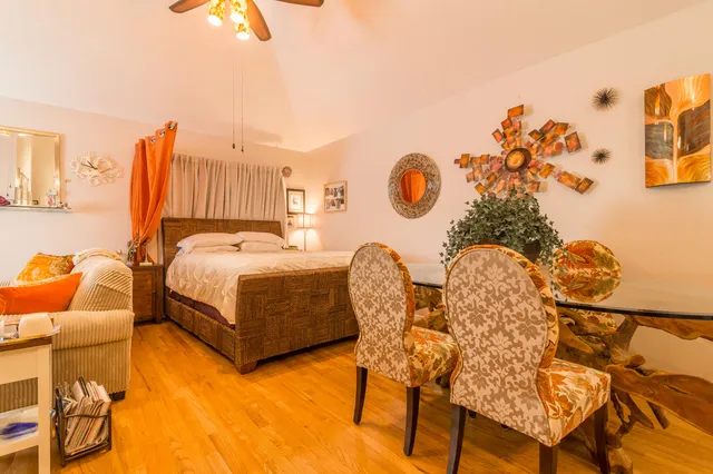 a kitchen with stainless steel appliances granite countertop a sink a stove cabinets and wooden floor