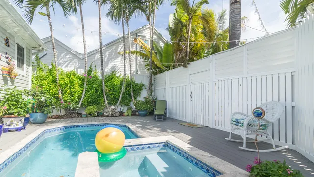 a view of a street with potted plants
